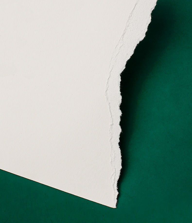 Close-up detail of torn 100% cotton watercolor paper, showing high-quality texture and fiber structure