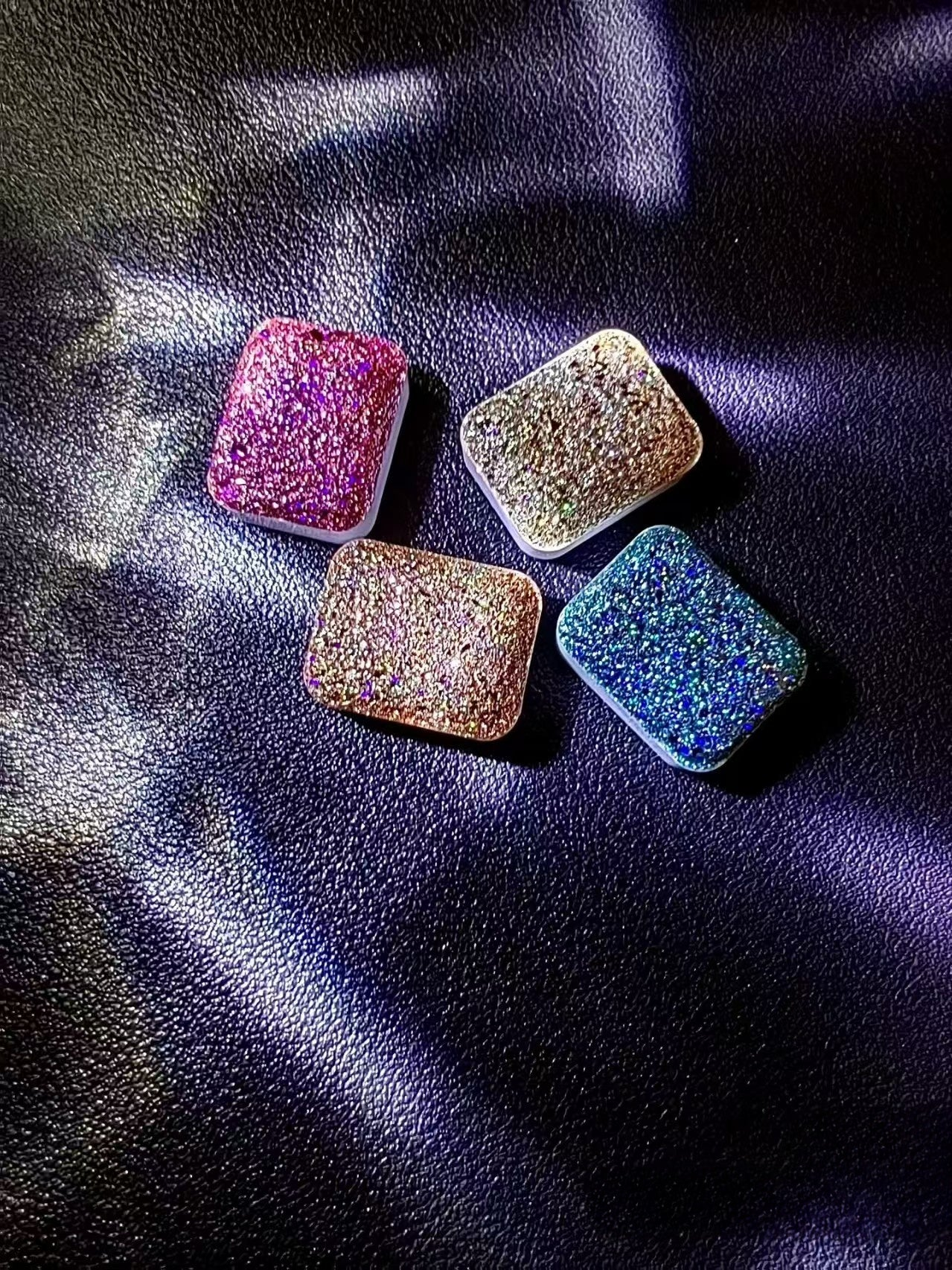 Close-up of handmade watercolor paint in a 1ml plastic pan – highlights color texture and detail