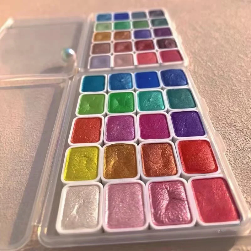 Multiple rectangle watercolor pans filled with different handmade paint colors – perfect for kits