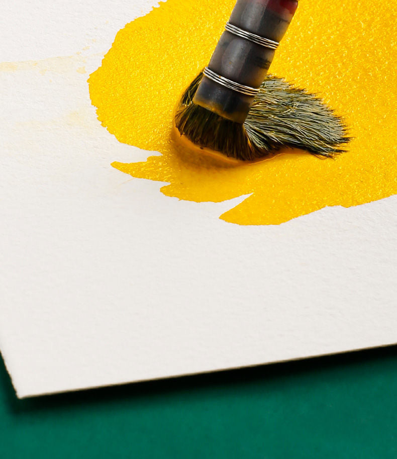 Yellow watercolor paint blending on 100% cotton watercolor paper, demonstrating smooth color diffusion and vibrant results