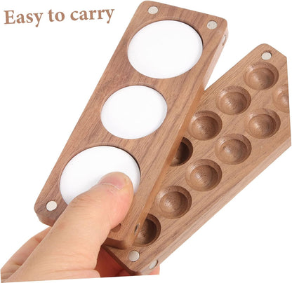 Detail of magnetic design on 12-round wooden palette for secure attachment during travel painting.